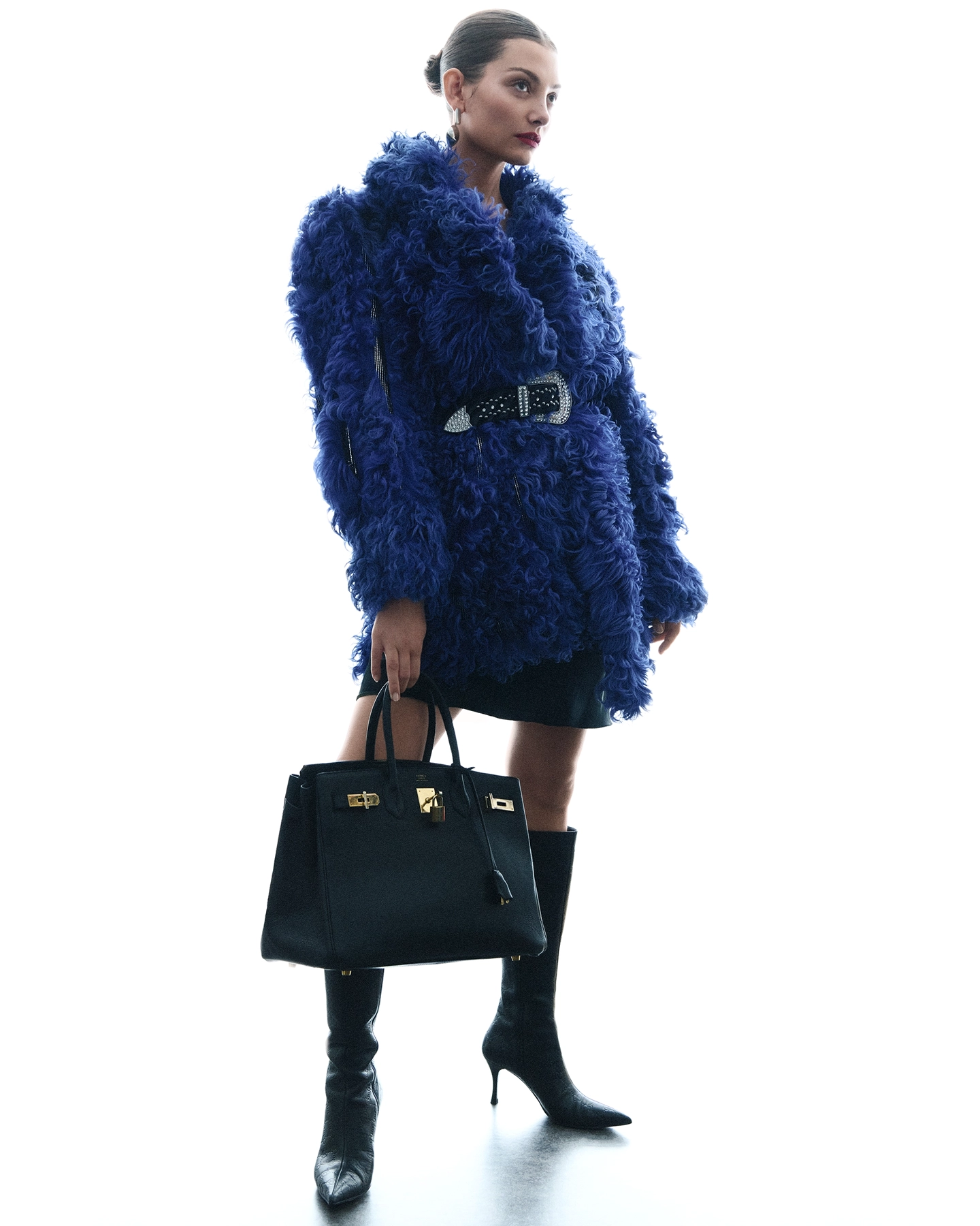Alice L in cobalt blue textured fur coat with black boots and structured bag for Sicky Magazine, styled by Olof Runmarker, makeup by Denise Löfstrand