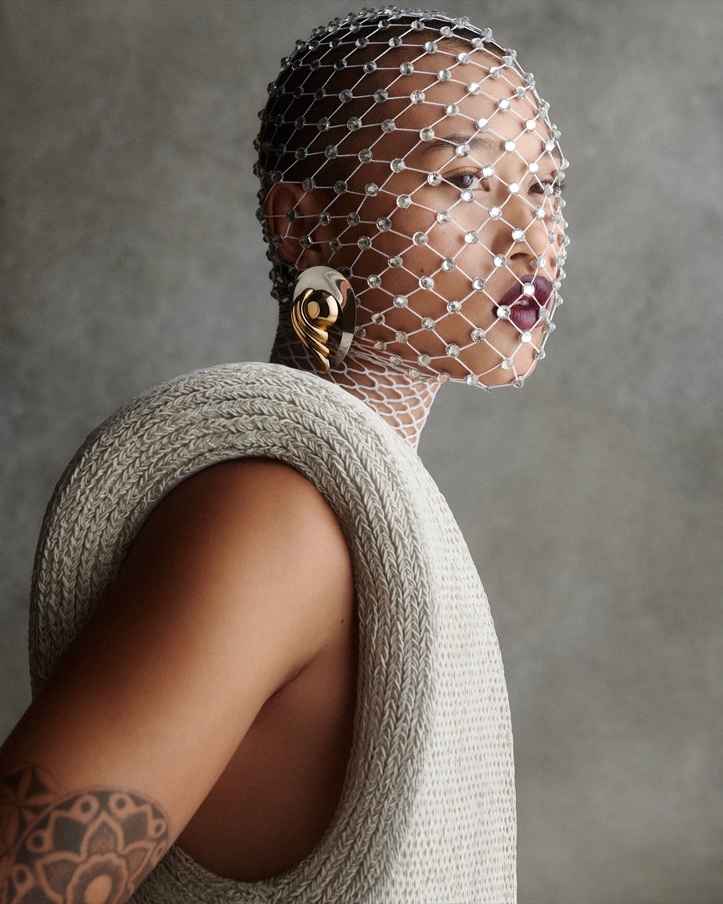 Elyse with crystal net veil over face, gold sculptural earring and knit top for Vogue Philippines, makeup by Mary-Jane Gotidoc, hair by Michael Kent, styled by Carlos Mangubat