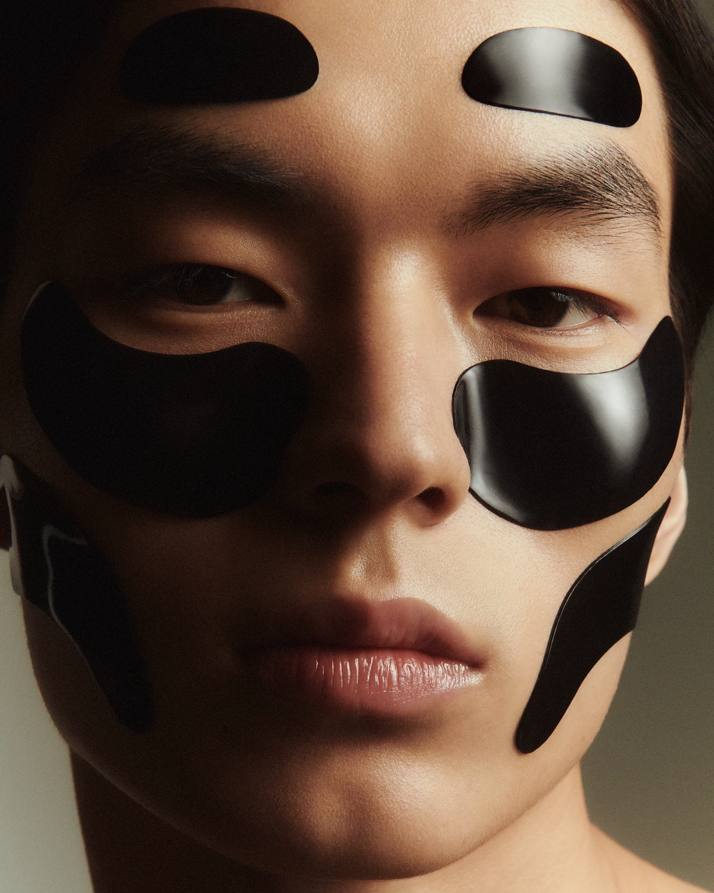 Nokal close-up with graphic black vinyl patches on face for Numero Netherlands in collaboration with A.D.C skincare