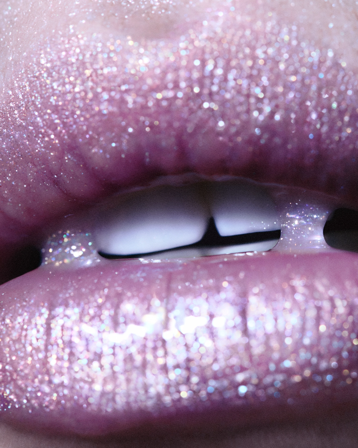 Extreme macro of glittering pink-lavender lips slightly parted for Sicky Magazine, makeup by Jeanette Gjerde Olsen